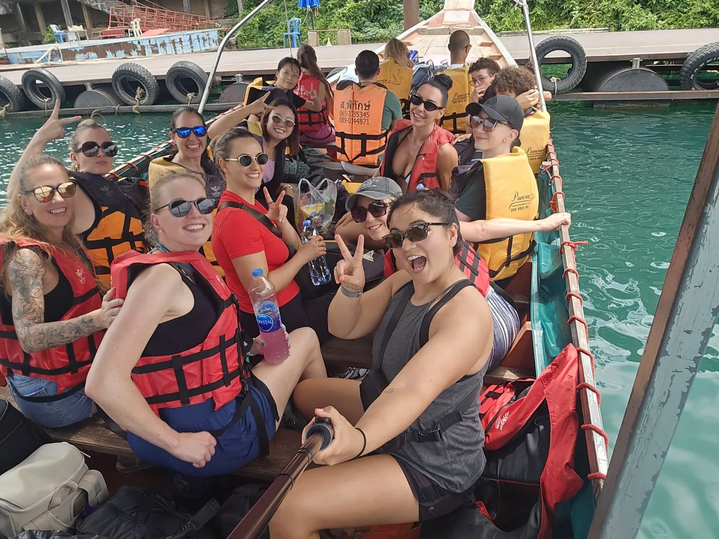The group in life jackets on a longtail boat