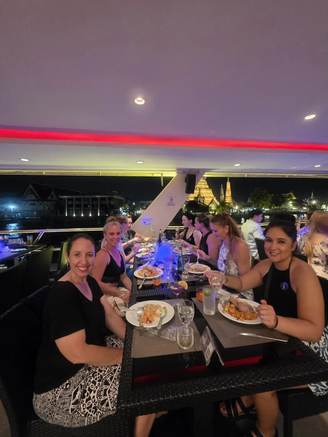 Dinner on a river cruise in Bangkok with Wat Arun lit up behind