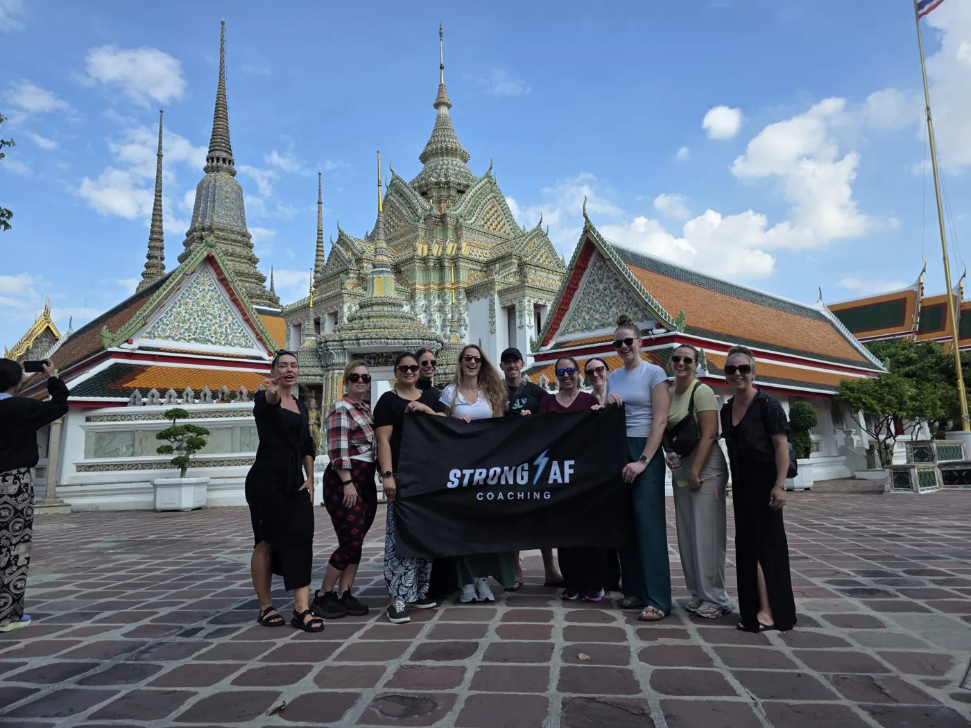 The Strong AF group with their banner at Wat Pho in Bangkok